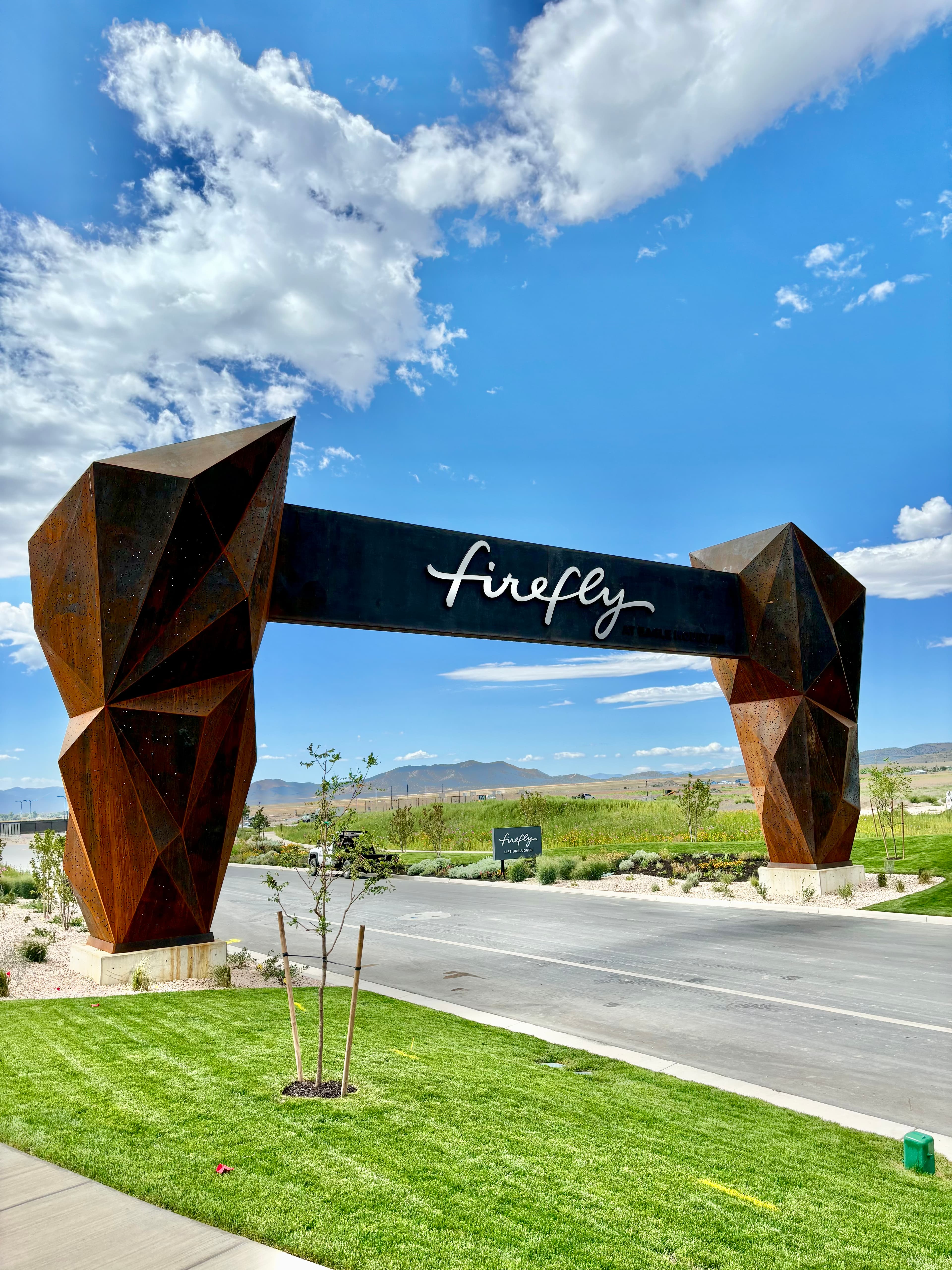 Firefly Entrance Arch - A monumental work of metal art that transforms a standard development entry into a sculptural landma...